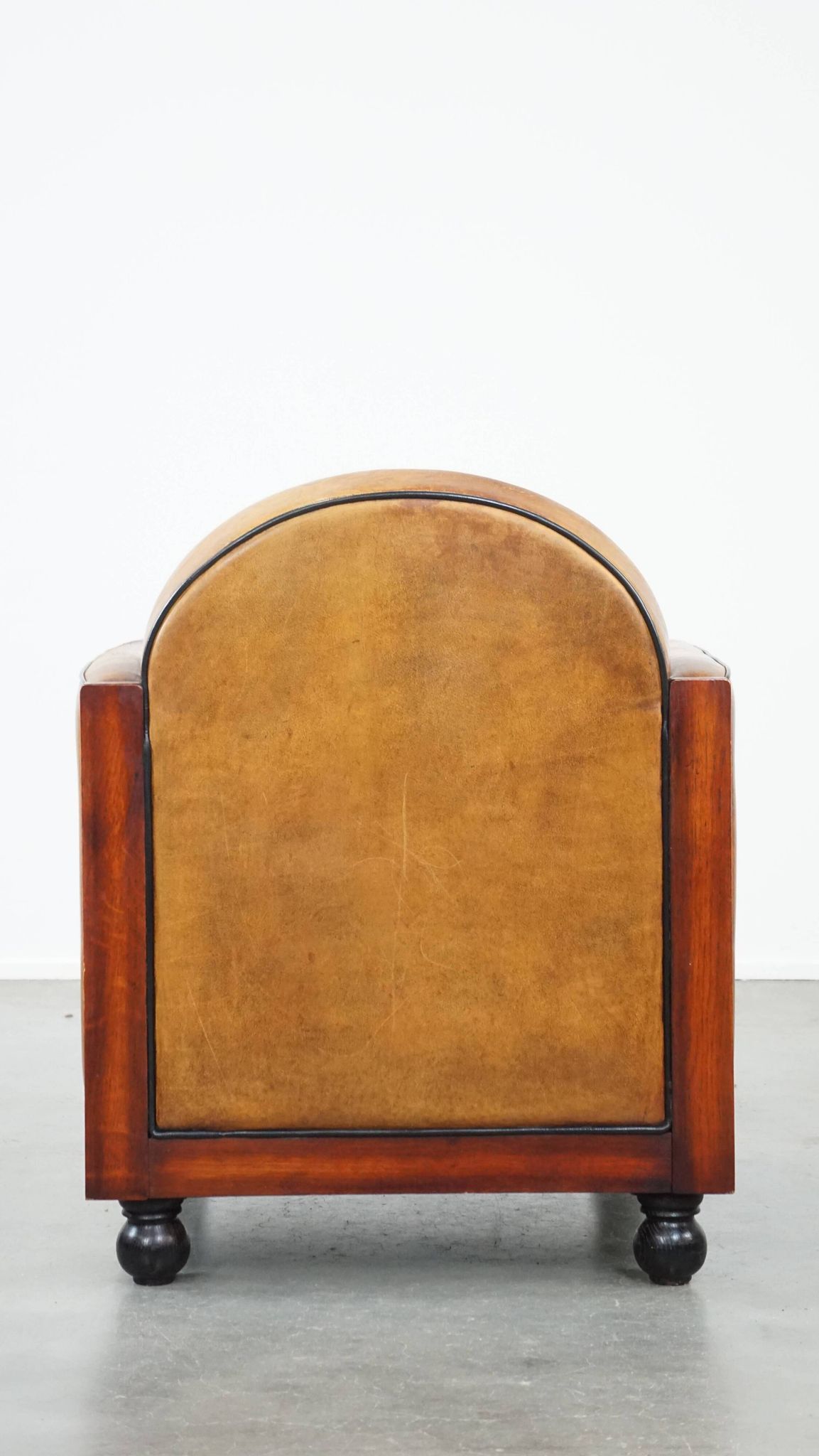 Sheep leather and wooden Art Deco design armchair with ball feet