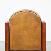 Sheep leather and wooden Art Deco design armchair with ball feet