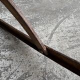 19th-century dark brown wrought-metal rocking chair with cognac leather sling seat, vintage