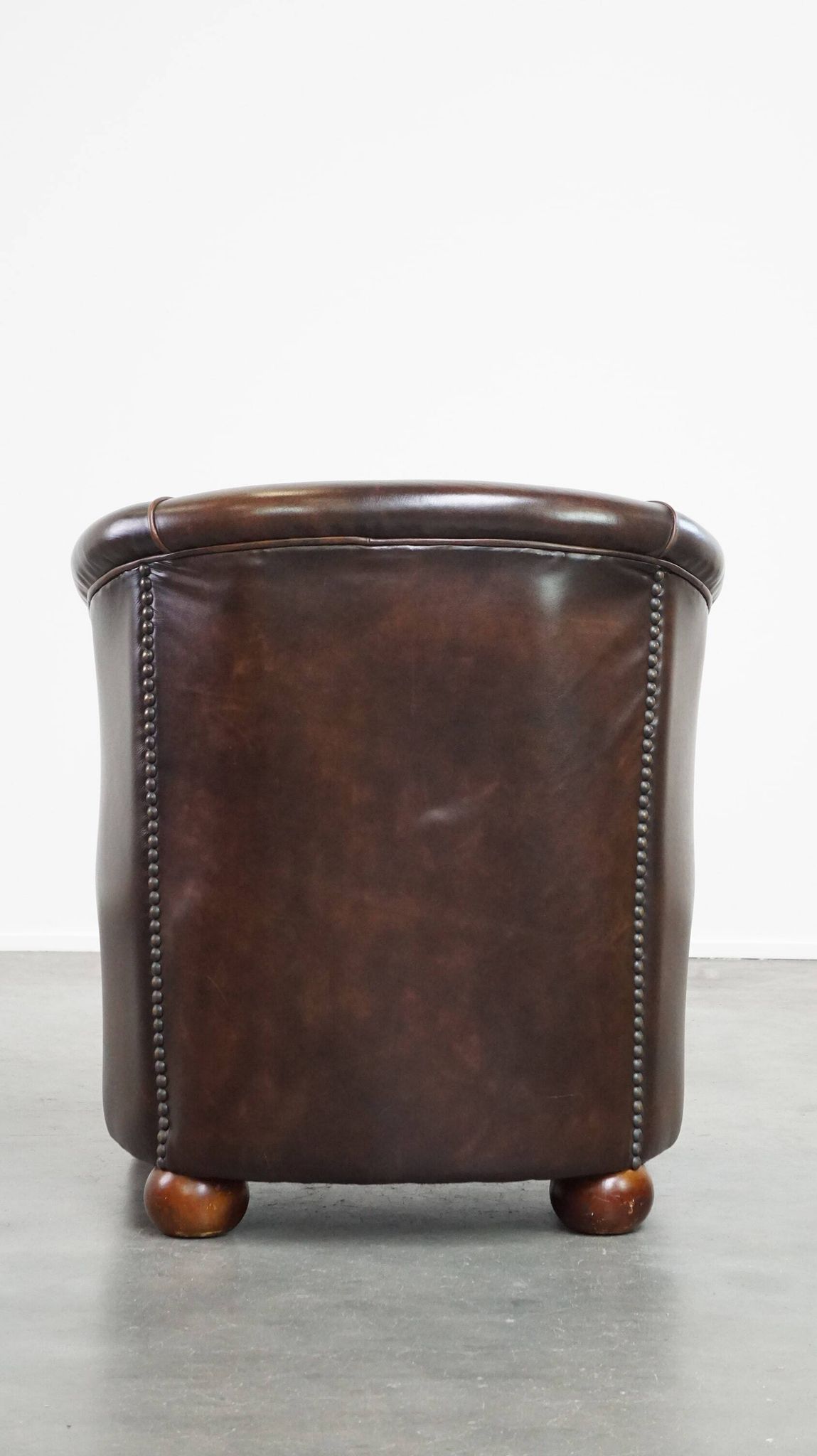 luxury dark leather club chair with English-style ball feet