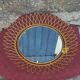 Vintage 1950s sun mirror in gold metal.
