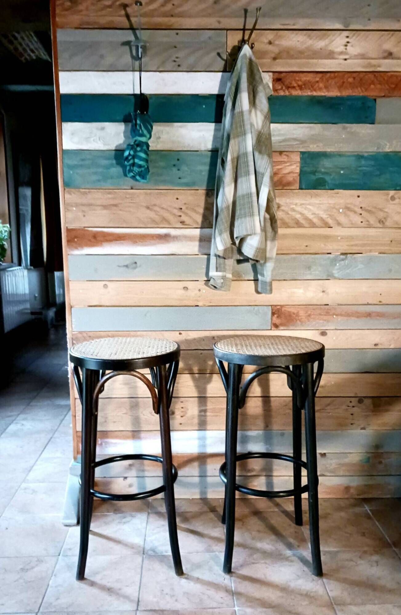 Set of 2 high bar stools made of wicker and rattan cane.
