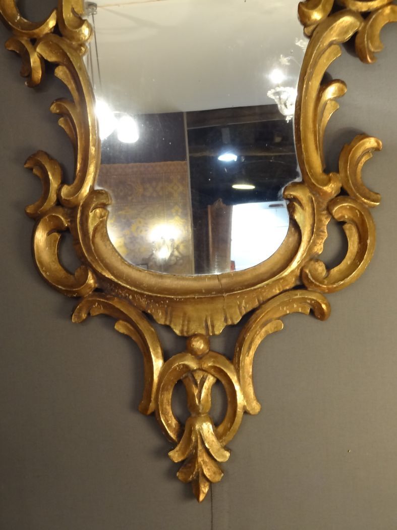 Carved and gilded wooden mirror with gold leaf 46 x 103 cm