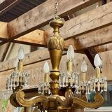 Golden wooden chandelier with crystal pendants from the 19th century.