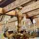 Golden wooden chandelier with crystal pendants from the 19th century.