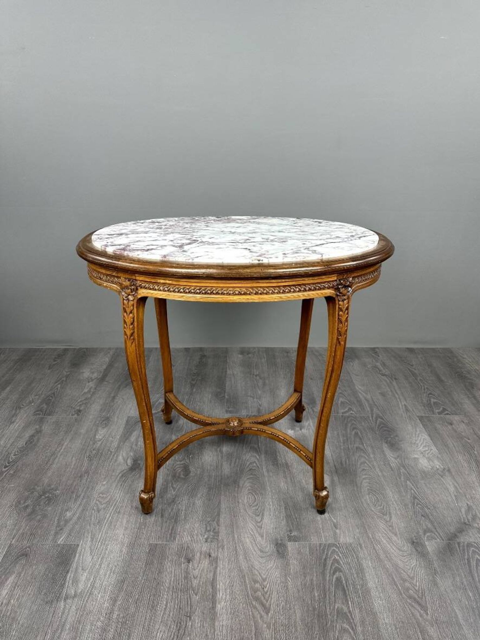 Oval guéridon table in carved wood and marble, Louis XVI style, 19th century.