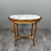 Oval guéridon table in carved wood and marble, Louis XVI style, 19th century.