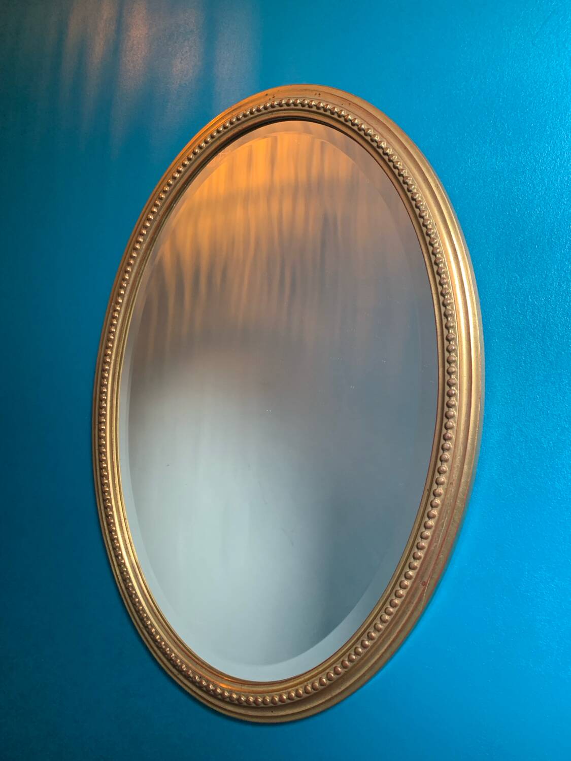 Vintage beveled gold oval mirror