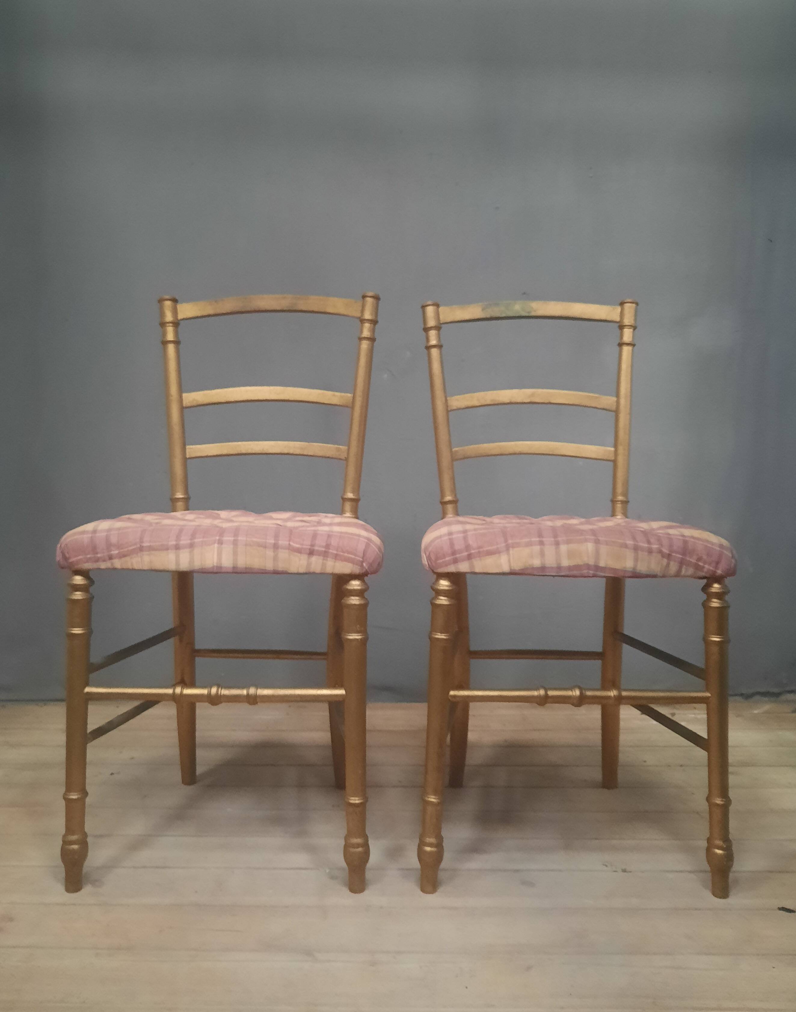Pair of upholstered chairs in gilded wood