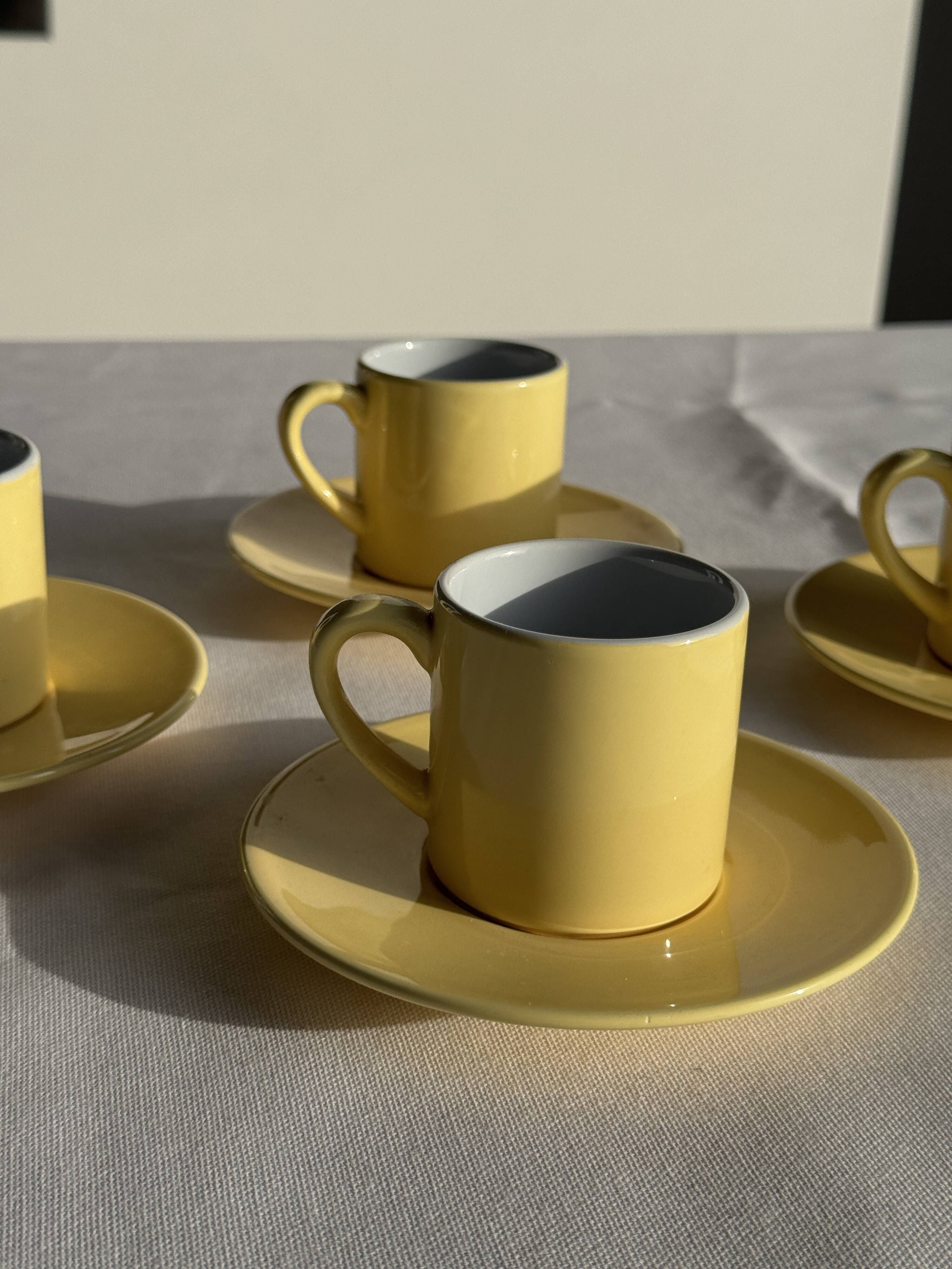 Set of 4 vintage yellow Italian espresso cups and saucers.
