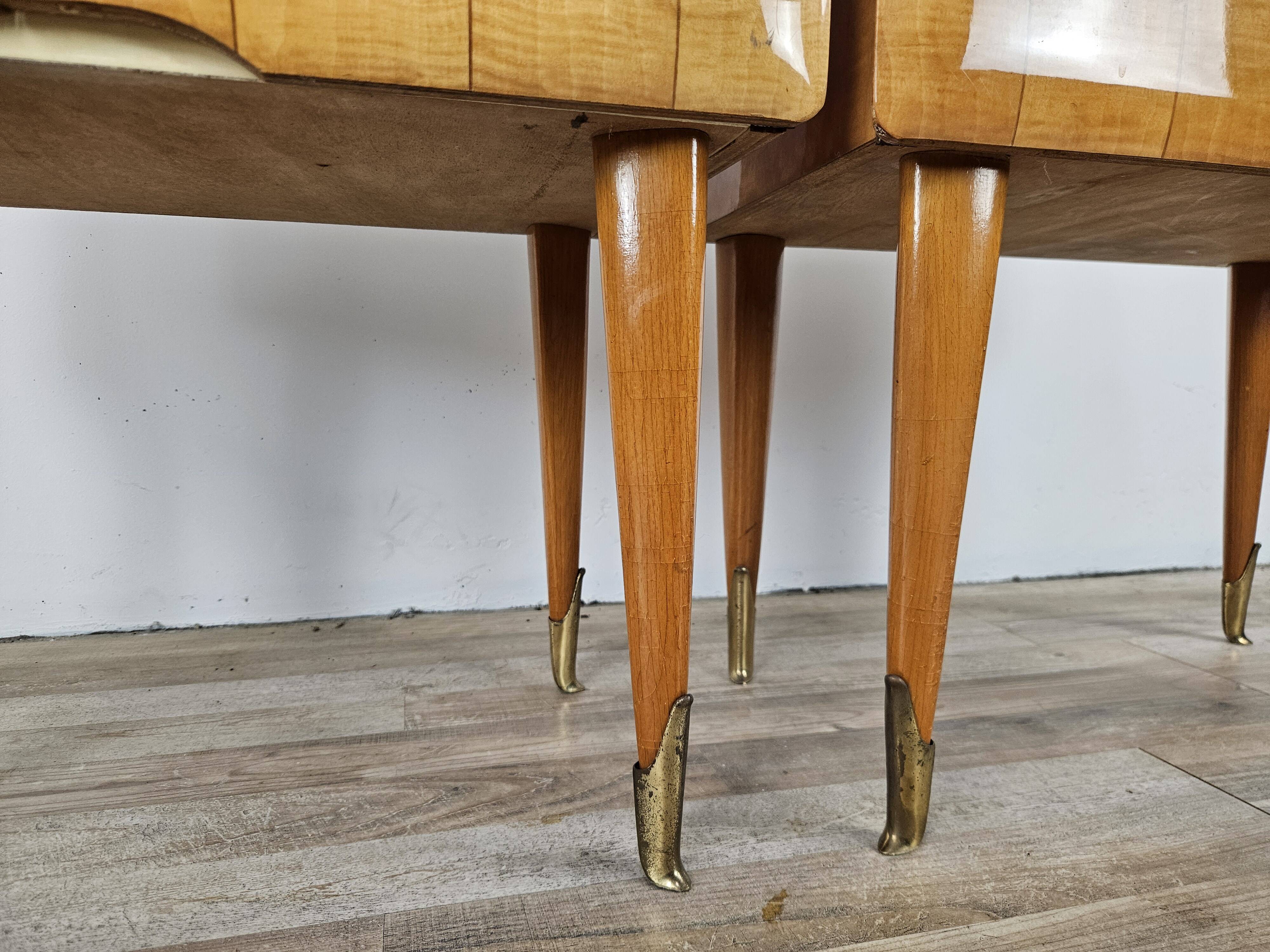 Mid-century nightstands in maple, brass, and glass