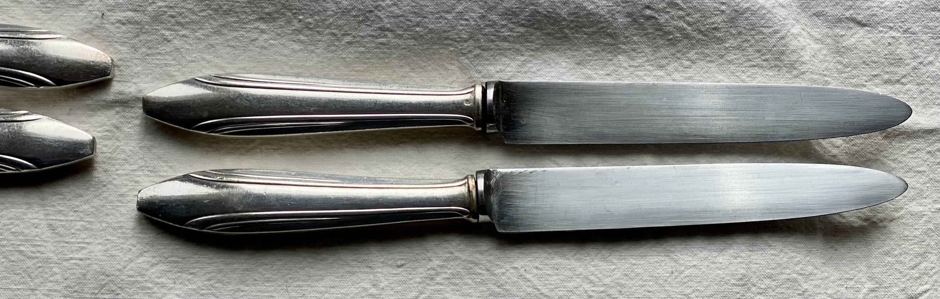 Set of 10 modernist silver-plated metal table knives.