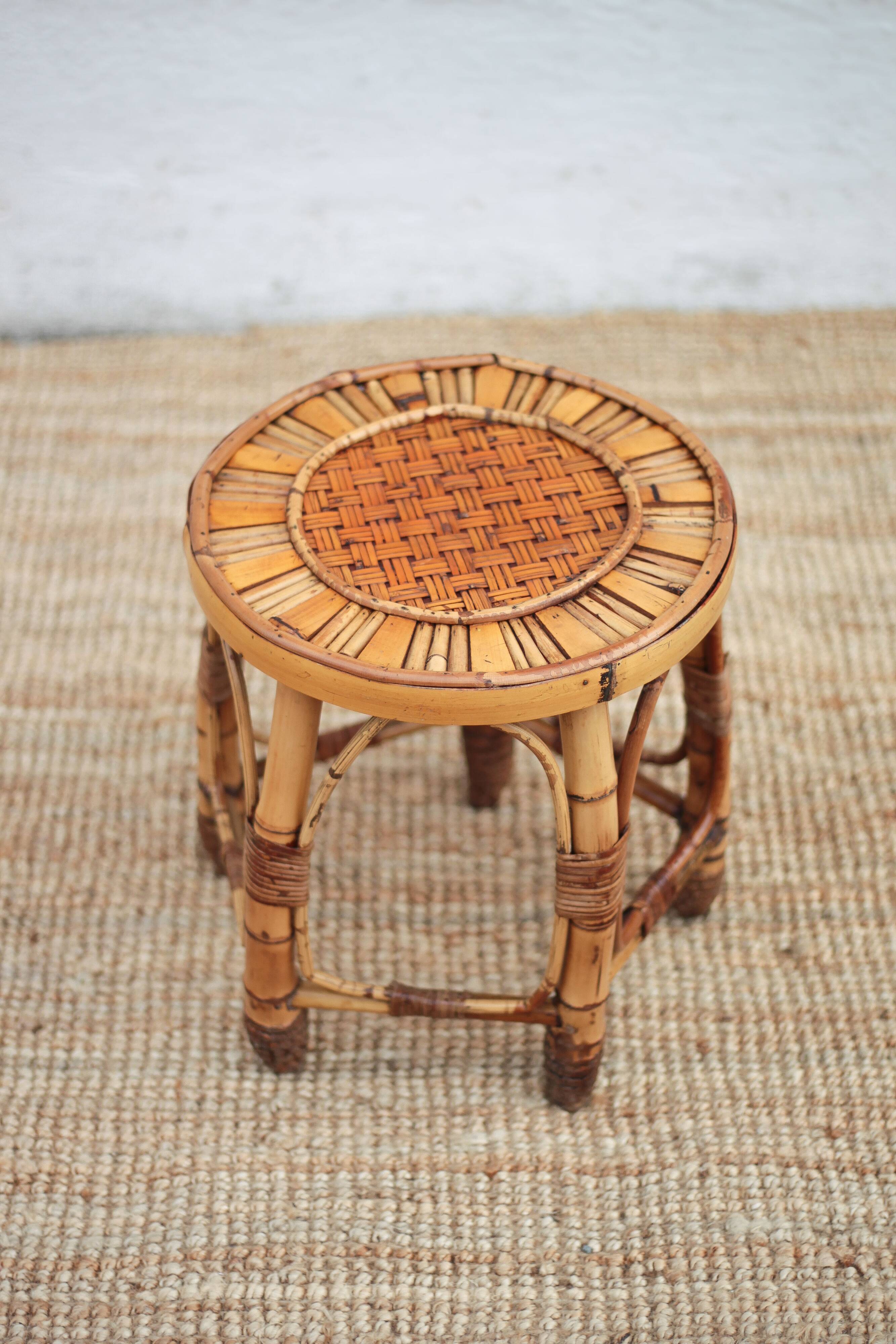 Vintage bamboo stool, woven rattan plant stand, interior decoration.