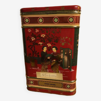 Old large empty commercial tea box with Asian decor. “Caramel flavor”.