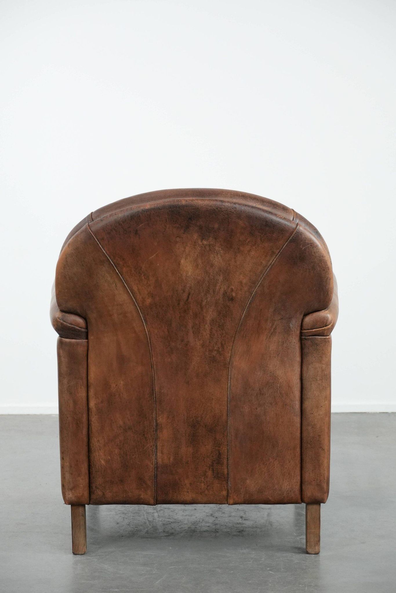 Vintage sheepskin armchair with warm colours and a characterful appearance