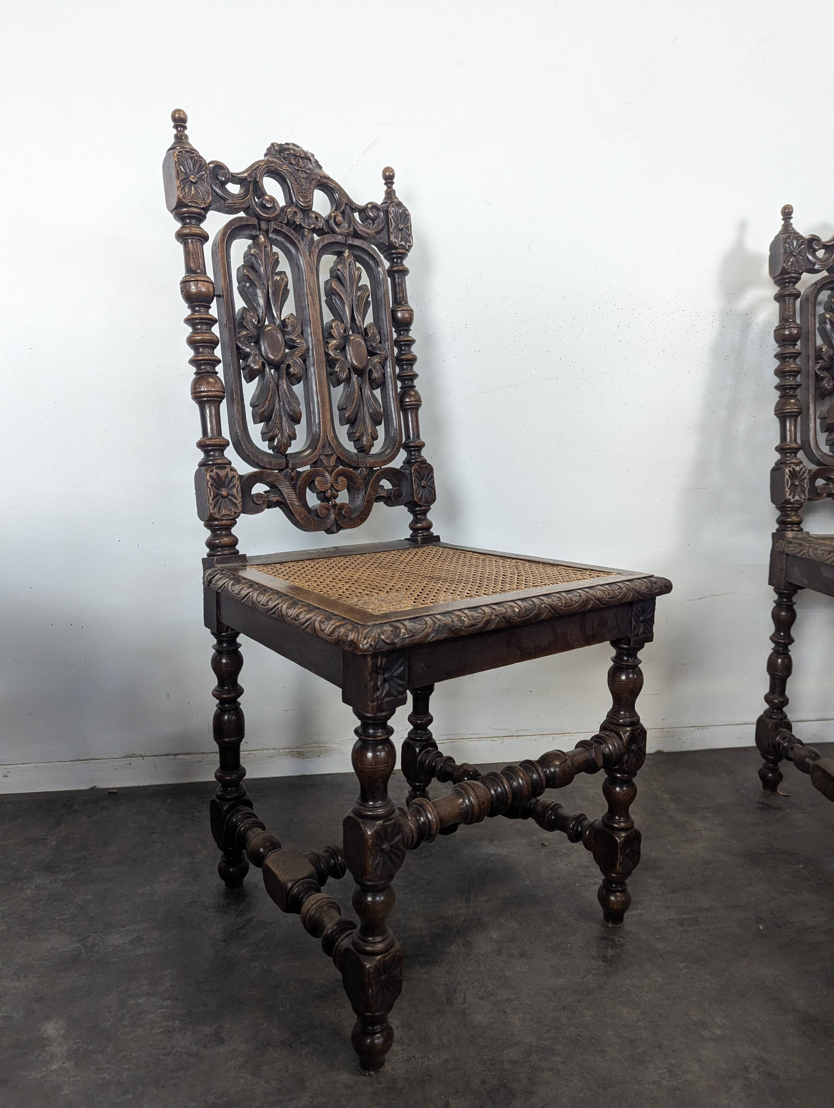 Set of 6 Henri II chairs in carved openwork oak with caned seats.