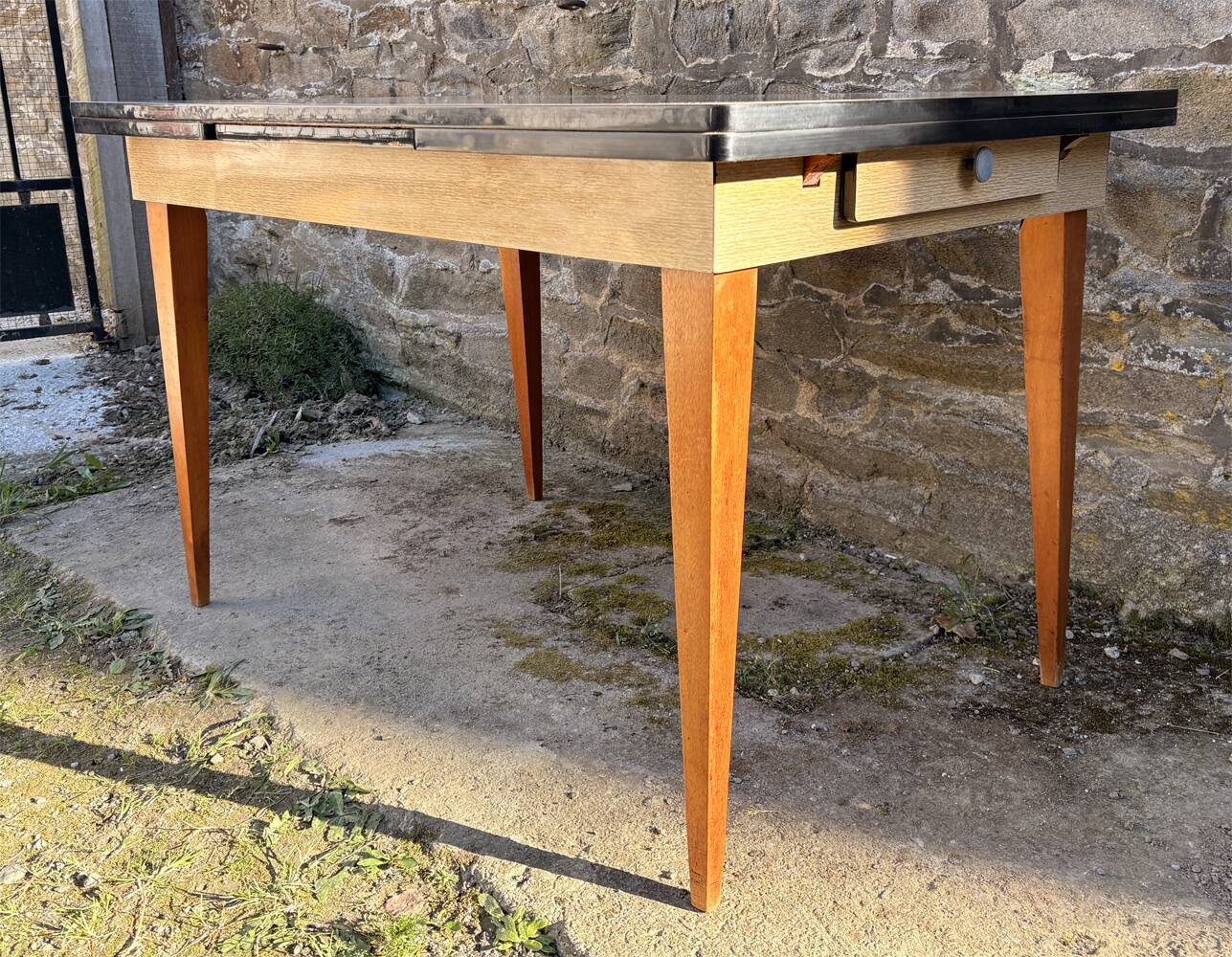 Beige French modernist extendable table, wooden legs, circa 1955.