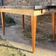 Beige French modernist extendable table, wooden legs, circa 1955.