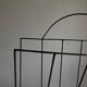 Mid-century poetic magazine rack in black metal