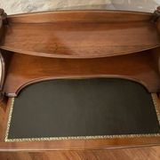 Vintage drop-leaf secretary with a green leather top and inlays.