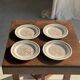 Set of 4 small dessert plates with a vintage stylised flower pattern.
