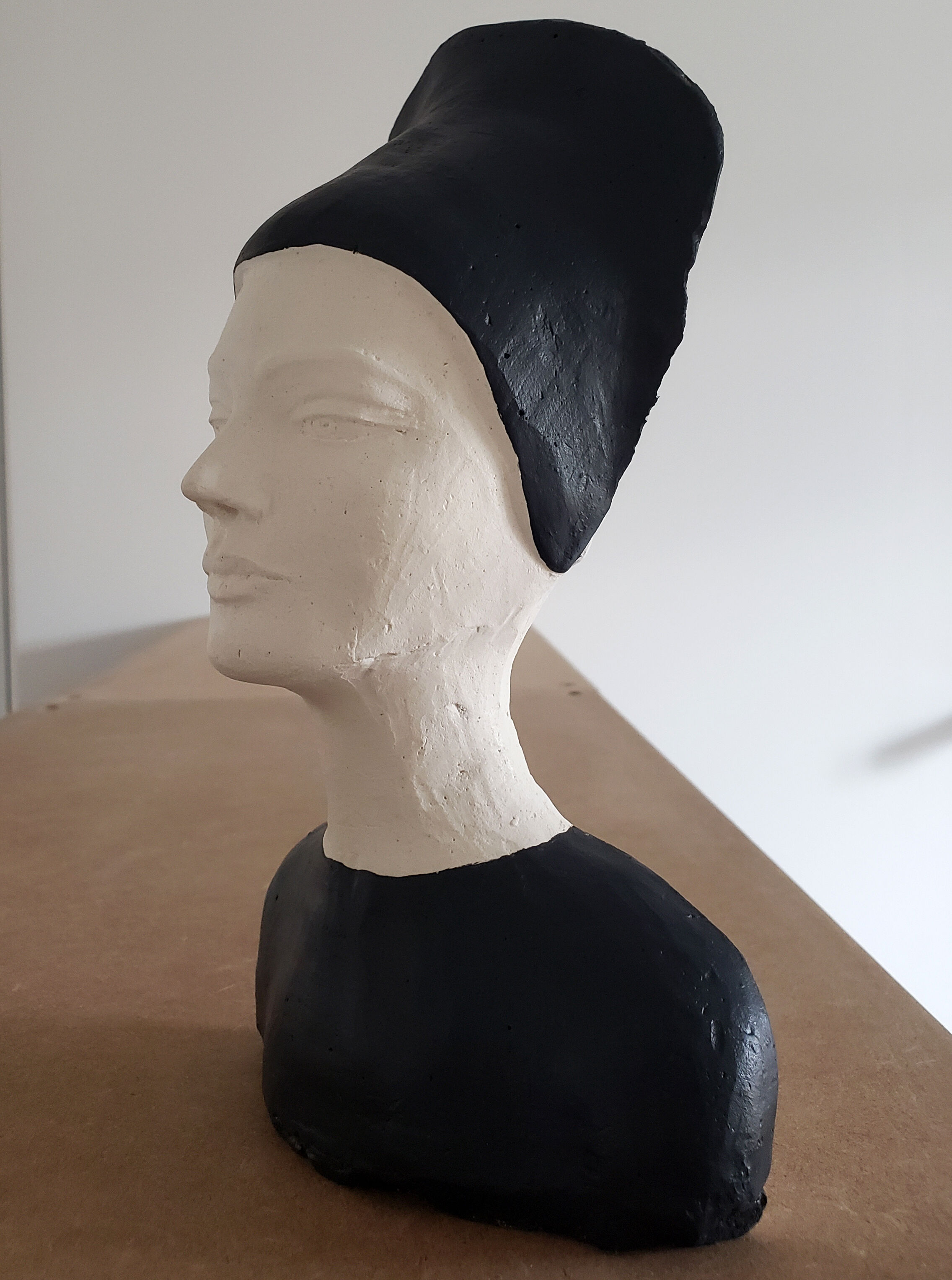 Bust of a woman in anthracite and white plaster