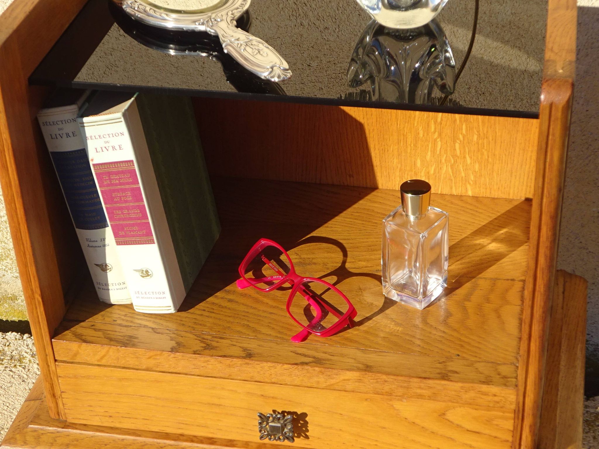Vintage oak bedside table with tapered legs.