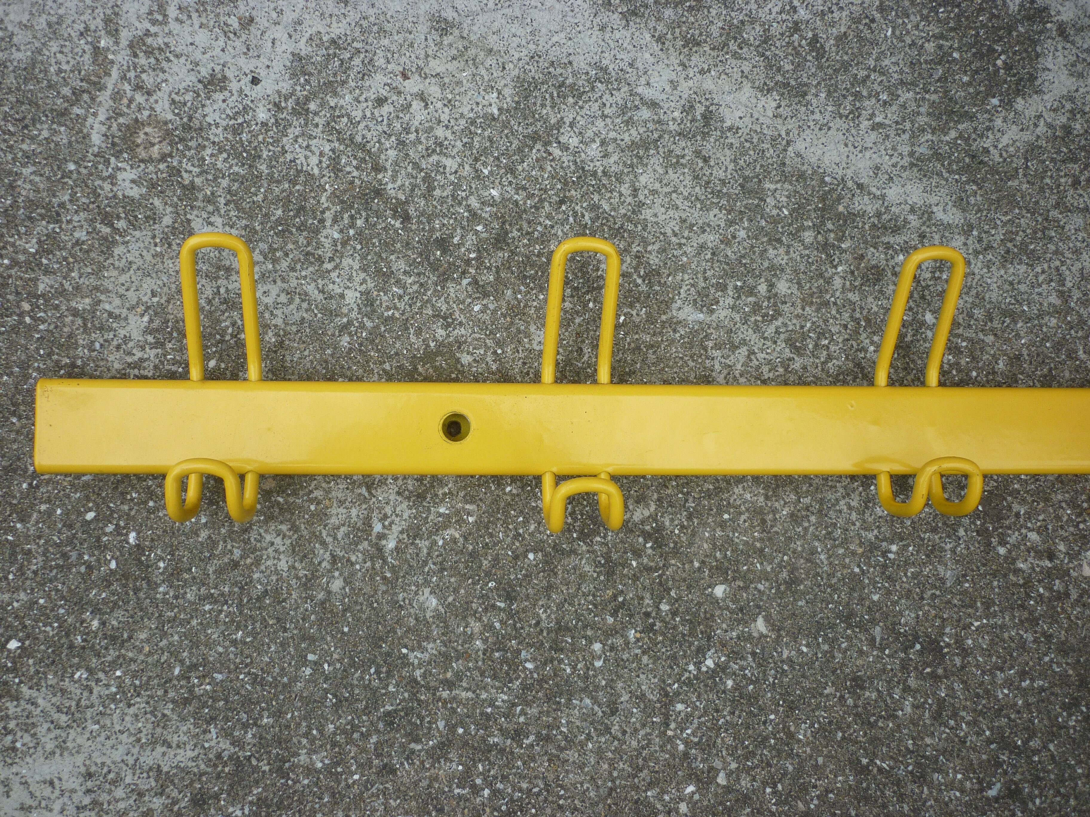 Yellow metal wall coat holder