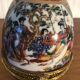 Egg-shaped porcelain jewelry box with asisaisues motifs