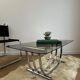 Smoked glass coffee table and chrome base by Yves Boutboul