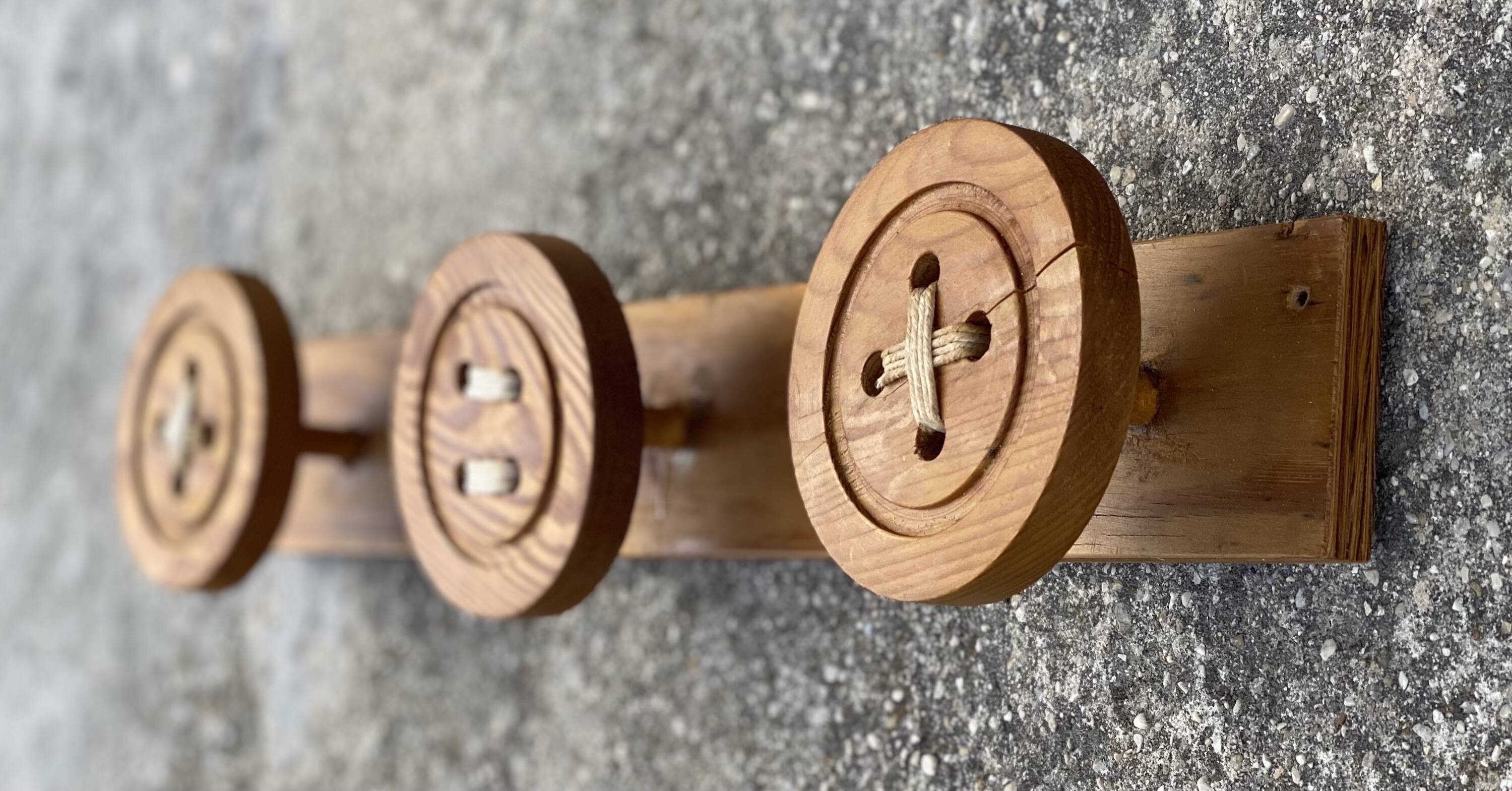 Vintage 1980 coat rack with 3 "button" hooks.
