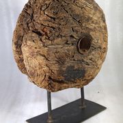 Old wooden pulley wheel on foot