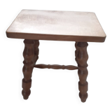 Rectangular wooden stool with 4 turned legs.
