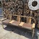 Baumann bench with wooden frame and faux leather seat.