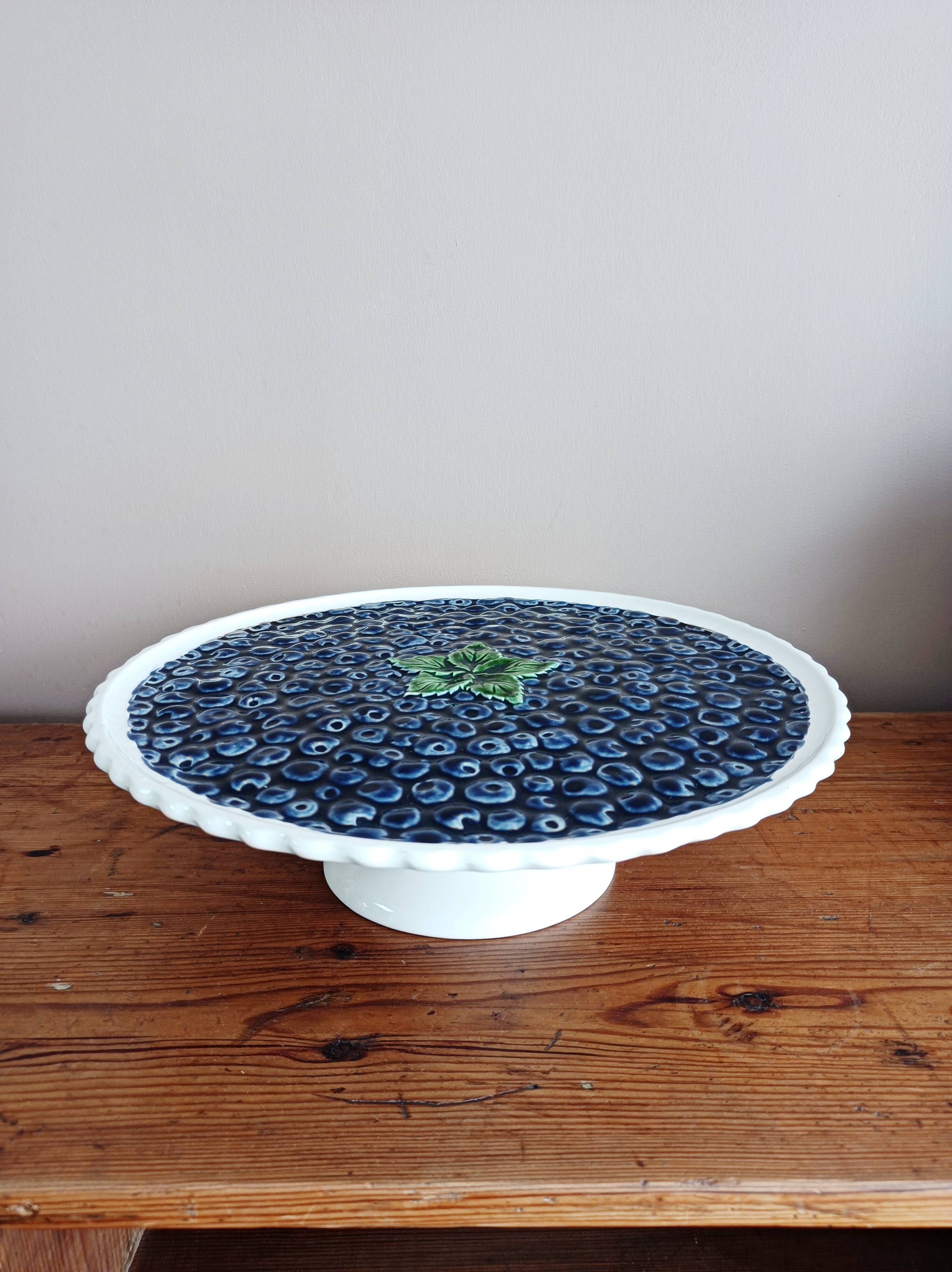 Pie dish on foot, in slip with blackberry decoration