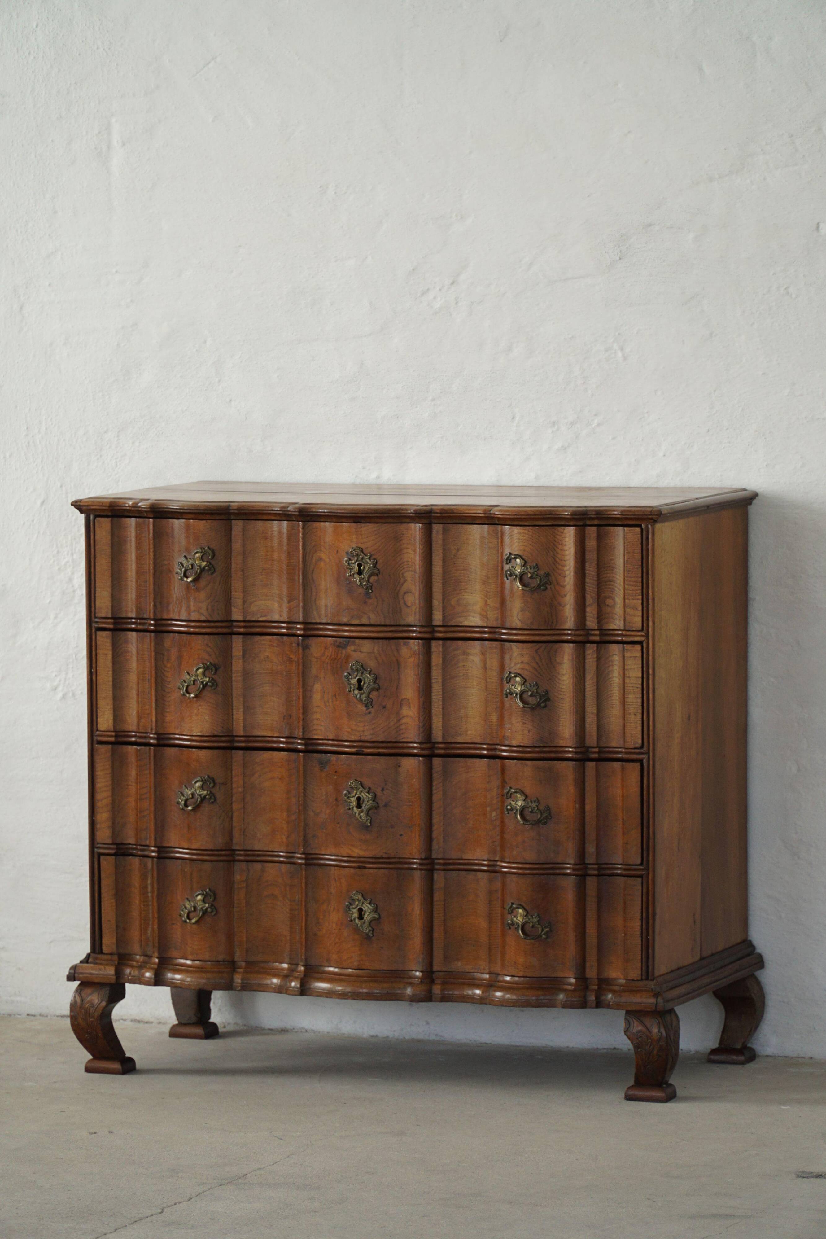 Antique baroque oak commode from the late 18th century with cabriole legs.