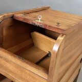 EAGLE in Paris. Wooden archive cabinet opening with two drawers and a curtain.