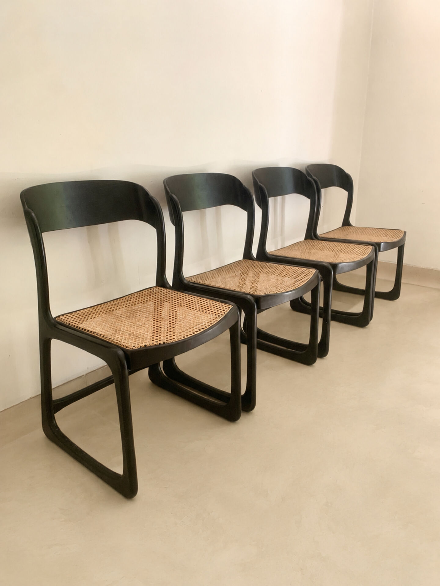 Set of 4 Baumann sled chairs with caning.