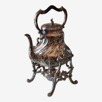 Ancient samovar tea fountain in silver metal