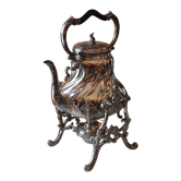 Ancient samovar tea fountain in silver metal