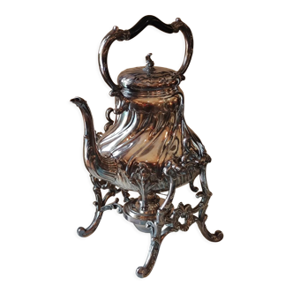 Ancient samovar tea fountain in silver metal