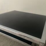 Pair of nesting tables in chromed metal and glass
