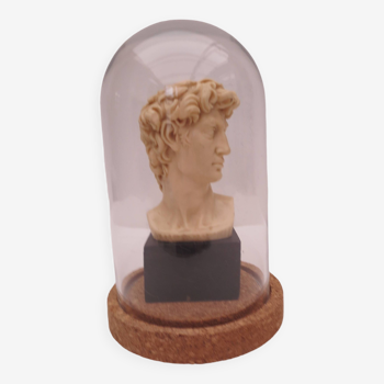 Small glass globe on base housing a figurine of “david”