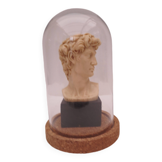 Small glass globe on base housing a figurine of “david”