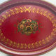 Old oval plate in painted red tin - floral decoration - early 20th century -