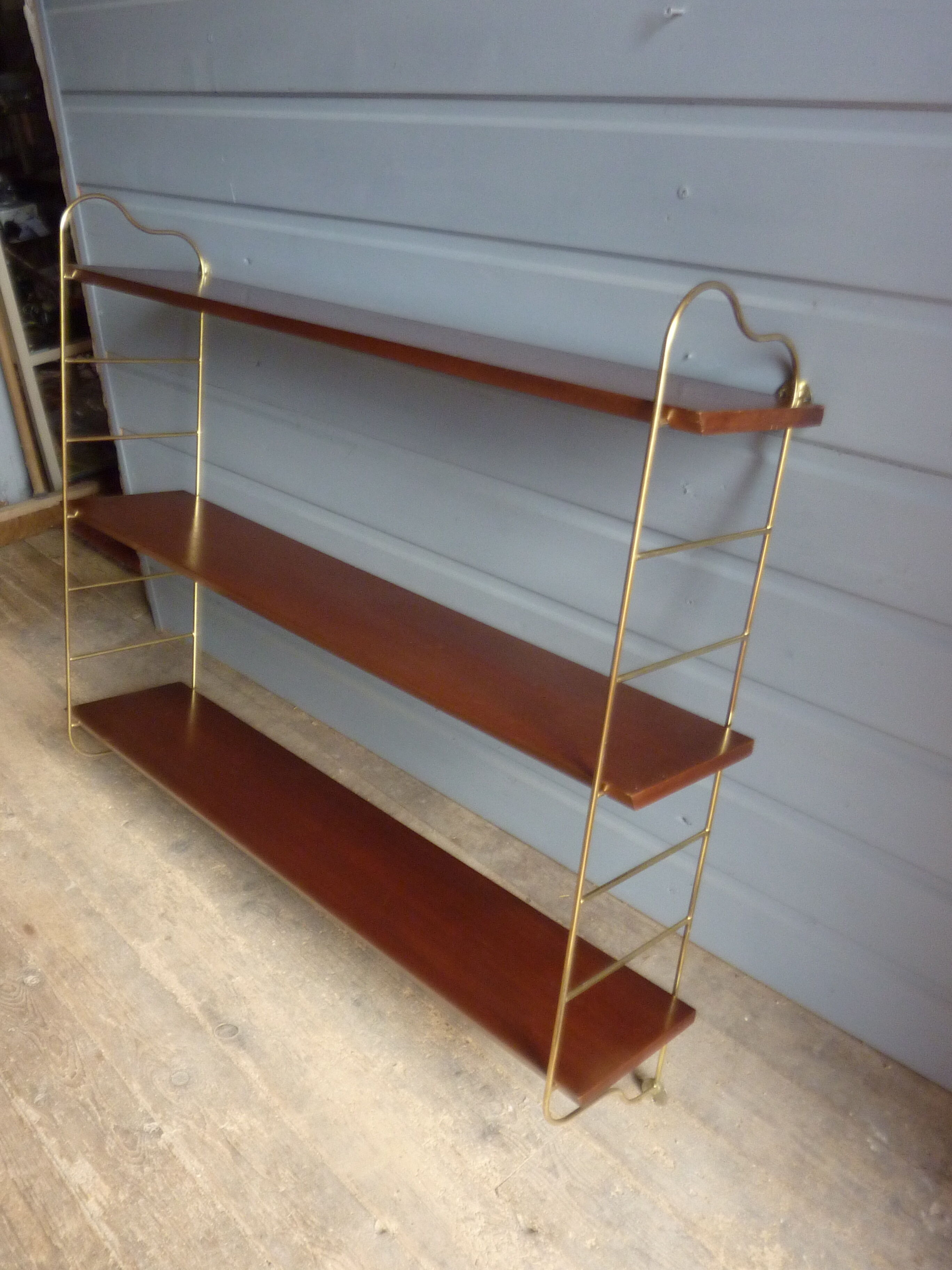 Wall shelves in brass and teak of the 1960s