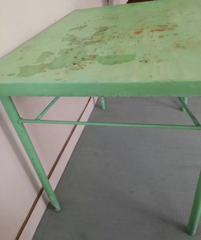Green garden table in patinated metal