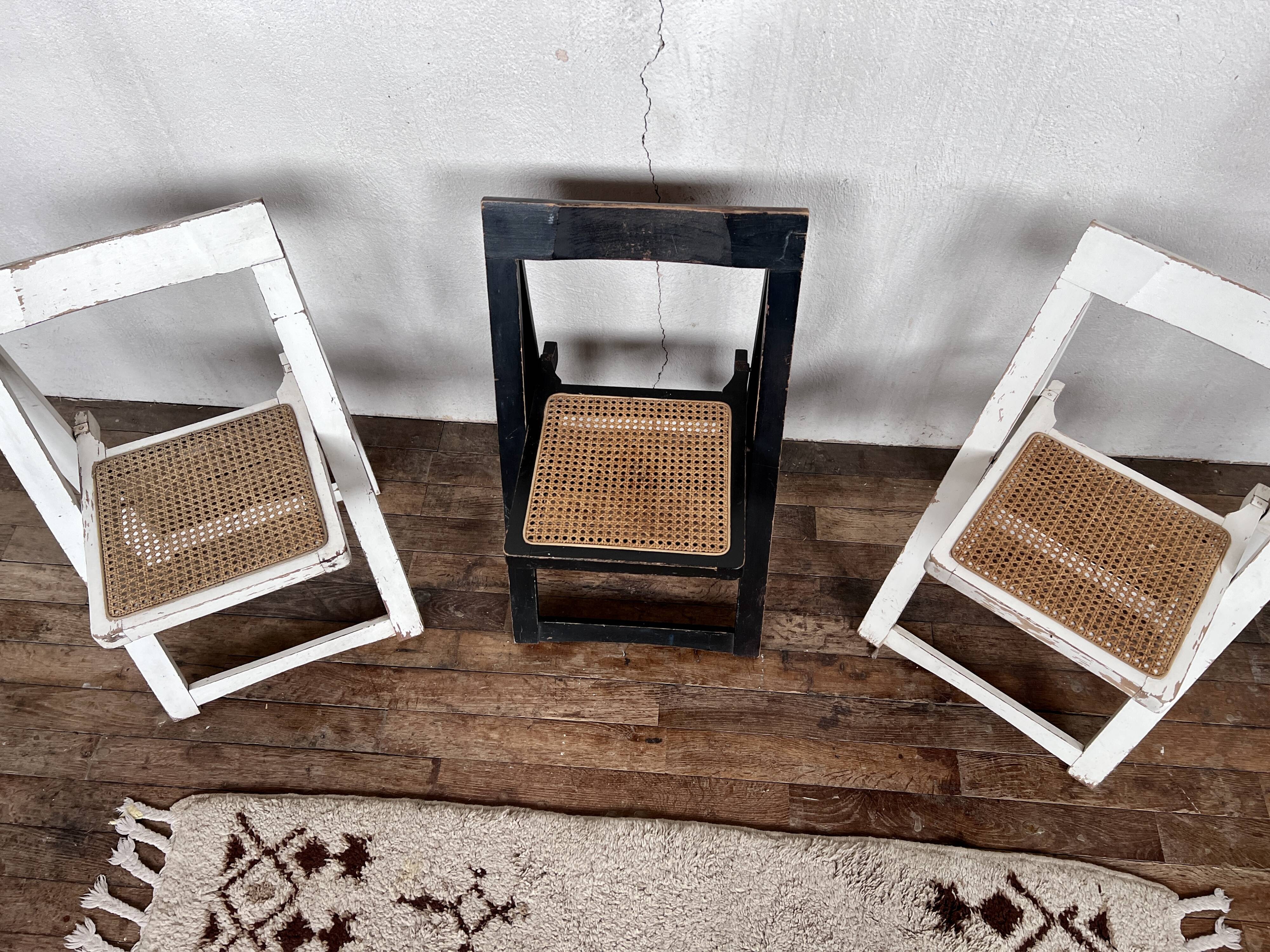 Trio of vintage folding chairs with canning and solid wood