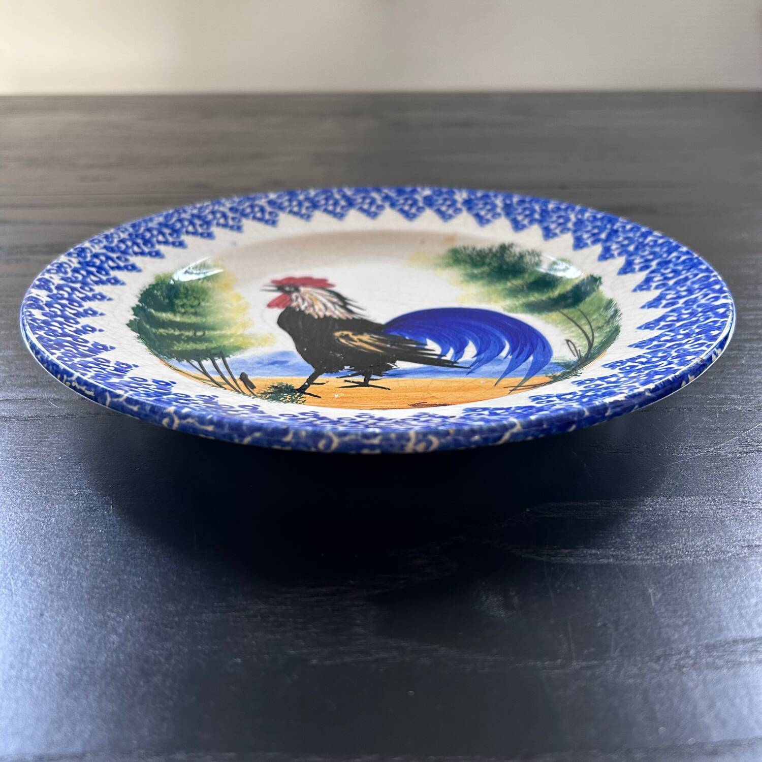 Old plate with rooster decoration