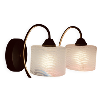 Pair of wall sconces with a swan neck in brass and a white glass shade.